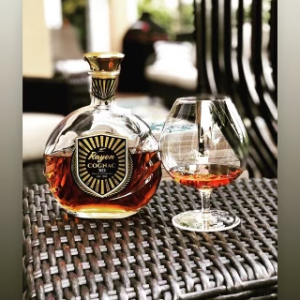 Rayon Cognac Bottle sitting next to glass of whiskey